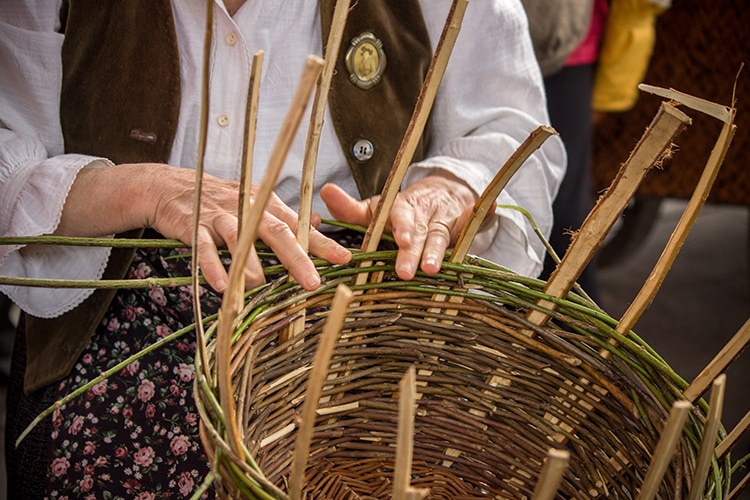 Artisan hands weaving a basket